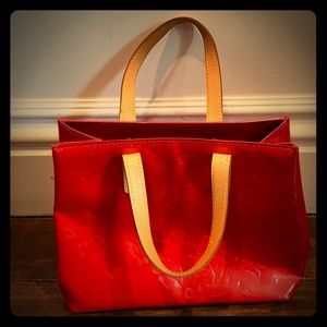 Red patent leather Louis Vuitton handbag